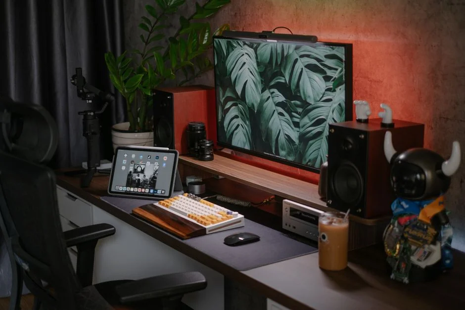 A stylish workspace featuring a laptop and monitors displaying design software.