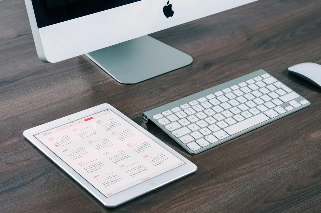 Business desk with laptop, coffee, and water glass, showcasing modern technology and productivity.